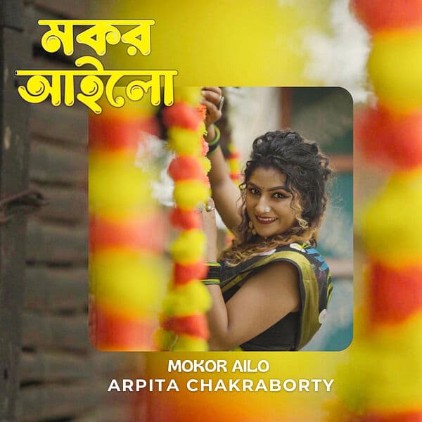 Cover artwork for her single “Mokor Ailo”, Arpita among marigold garlands
